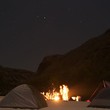 Campfire and delicious food on an overnight rafting trip