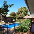 Tabonina Guesthouse - View from the gazebo: swimming pool, chalet, twin rooms (right)