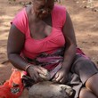 Woman dehulling the Mungongo Fruit